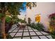 Charming backyard patio with a modern design, featuring pavers, landscaping, and outdoor seating for dining or relaxation at 1954 Goldenrod St, Sarasota, FL 34239