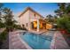 Stunning backyard oasis featuring a sparkling pool, covered patio, and lush landscaping perfect for relaxation and entertaining at 1954 Goldenrod St, Sarasota, FL 34239