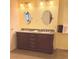 Bathroom featuring double sinks, granite countertop, and elegant fixtures at 20170 Tralee Dr, Port Charlotte, FL 33952