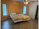 Cozy bedroom featuring two windows, wood-look floors, and a ceiling fan at 20170 Tralee Dr, Port Charlotte, FL 33952