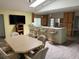 Dining area and kitchen with lots of seating, tile floors, and bright pendant lighting at 20170 Tralee Dr, Port Charlotte, FL 33952