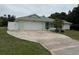 Charming single-story home featuring a well-maintained front yard and a two-car garage with an extended driveway at 20170 Tralee Dr, Port Charlotte, FL 33952