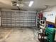 Spacious two-car garage with storage shelves to maximize space and organization at 20170 Tralee Dr, Port Charlotte, FL 33952