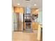 Modern kitchen features stainless steel appliances, wooden cabinetry, and a sleek range hood at 20170 Tralee Dr, Port Charlotte, FL 33952