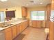 Spacious kitchen with granite countertops, wooden cabinets, and stainless steel appliances at 20170 Tralee Dr, Port Charlotte, FL 33952