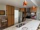 Kitchen with stainless steel appliances, granite countertops, oak cabinets, and tile backsplash at 20170 Tralee Dr, Port Charlotte, FL 33952