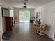 Bright living room with tile floors, ceiling fan, and sliding glass doors to outside at 20170 Tralee Dr, Port Charlotte, FL 33952