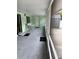 Covered patio with neutral tones, screened windows and access to backyard storage at 20170 Tralee Dr, Port Charlotte, FL 33952