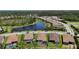 Community aerial view of new homes near a lake featuring lush landscaping and a tranquil setting at 208 Ariano Ave, Nokomis, FL 34275