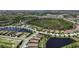 Aerial view of a Primary planned community with lakes, a recreation center, and lush landscaping at 208 Ariano Ave, Nokomis, FL 34275
