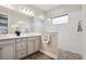 Bright bathroom featuring double vanity, glass shower with pebble floor, and wood-look tile at 208 Ariano Ave, Nokomis, FL 34275
