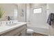Bright bathroom showcasing a vanity with granite countertop and shower/tub combo at 208 Ariano Ave, Nokomis, FL 34275