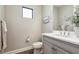 Powder room showcasing vanity with light countertop, framed art, and tiled floors at 208 Ariano Ave, Nokomis, FL 34275