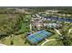 Aerial view of a tennis court and community pool, showcasing resort-style amenities at 208 Ariano Ave, Nokomis, FL 34275