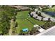 Aerial view of a fenced dog park with shelters, surrounded by landscaping, in a residential neighborhood at 208 Ariano Ave, Nokomis, FL 34275