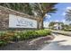 Stone community sign surrounded by lush landscaping, showcasing the community's entrance at 208 Ariano Ave, Nokomis, FL 34275