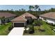Charming single-story home with a tile roof, well-manicured landscaping, and a two-car garage at 208 Ariano Ave, Nokomis, FL 34275