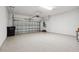 Spacious garage with speckled flooring, automatic door, and ample room for vehicles at 208 Ariano Ave, Nokomis, FL 34275