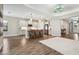 Open-concept kitchen featuring white cabinets, stainless steel appliances, and a breakfast bar at 208 Ariano Ave, Nokomis, FL 34275