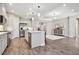 Modern kitchen with stainless steel appliances, a central island and open access to the living area at 208 Ariano Ave, Nokomis, FL 34275