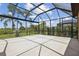 Screened lanai overlooking the fenced backyard with mature trees and lush landscaping at 208 Ariano Ave, Nokomis, FL 34275