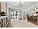 Bright living area featuring wood floors, tray ceiling, and sliding glass doors to outdoor patio at 208 Ariano Ave, Nokomis, FL 34275