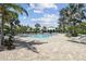 Community pool area featuring ample seating, tropical landscaping, and luxurious resort atmosphere at 208 Ariano Ave, Nokomis, FL 34275