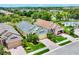 Aerial view of residences showing landscaped yards and a glimpse of a community pool area at 2085 Mattamy Ct, Venice, FL 34292