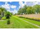Well-maintained backyard features manicured lawn and landscaping along the property's perimeter wall at 2085 Mattamy Ct, Venice, FL 34292