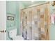 Bright bathroom with a toilet, shower, and decorative recessed shelf at 2085 Mattamy Ct, Venice, FL 34292
