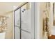Ensuite bathroom showcasing tiled shower with glass door and coordinated towel racks and fixtures at 2085 Mattamy Ct, Venice, FL 34292