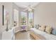 Bright bonus room filled with natural light through many windows, creating a warm and inviting space at 2085 Mattamy Ct, Venice, FL 34292