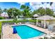 Inviting community pool with ample seating, lush landscaping, and a convenient covered cabana area at 2085 Mattamy Ct, Venice, FL 34292
