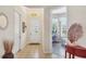 Welcoming foyer with tile flooring and view into a sunlit bonus room featuring many windows at 2085 Mattamy Ct, Venice, FL 34292