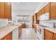 Spacious kitchen featuring wooden cabinets, white appliances, light countertops, and tile flooring at 2085 Mattamy Ct, Venice, FL 34292