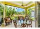 Screened lanai features an outdoor seating area for relaxation with view of backyard at 2085 Mattamy Ct, Venice, FL 34292