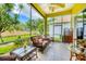 Beautiful screened in lanai with stylish furniture for outdoor entertainment at 2085 Mattamy Ct, Venice, FL 34292