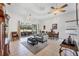 Spacious living room with a ceiling fan, tile flooring, and sliding doors leading to the backyard at 2085 Mattamy Ct, Venice, FL 34292