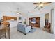 Bright living room showcasing tile flooring, an entertainment center, and an open layout for easy living at 2085 Mattamy Ct, Venice, FL 34292