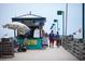 A scene from the pier features a bait and snack shop and people walking on the pier at 2085 Mattamy Ct, Venice, FL 34292