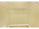 Bright walk-in closet with shelving and wood-look flooring provides excellent storage at 2085 Mattamy Ct, Venice, FL 34292