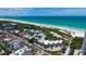 Aerial view of a beachfront condo community with a swimming pool and stunning ocean views at 222 Beach Rd # 7, Sarasota, FL 34242