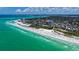 Stunning aerial view of beachfront condo community with pristine white sand beach and turquoise water at 222 Beach Rd # 7, Sarasota, FL 34242