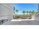 Spacious balcony overlooking a lushly landscaped beachfront with palm trees and a glimpse of the ocean at 222 Beach Rd # 7, Sarasota, FL 34242