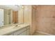 Bathroom with a single sink vanity, patterned wallpaper, and a shower in the background at 222 Beach Rd # 7, Sarasota, FL 34242