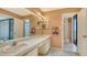 This bathroom features a double sink vanity and access to the shower and balcony at 222 Beach Rd # 7, Sarasota, FL 34242