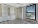 Bedroom featuring a bright window with blinds and white built in storage cabinets at 222 Beach Rd # 7, Sarasota, FL 34242