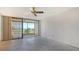 Spacious bedroom features a ceiling fan and sliding glass doors to a private balcony at 222 Beach Rd # 7, Sarasota, FL 34242