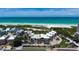 Beachfront condo exterior showcasing modern architecture and lush landscaping with palm trees at 222 Beach Rd # 7, Sarasota, FL 34242