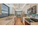 Well-lit kitchen with stainless appliances, white cabinets, and designer wallpaper at 222 Beach Rd # 7, Sarasota, FL 34242